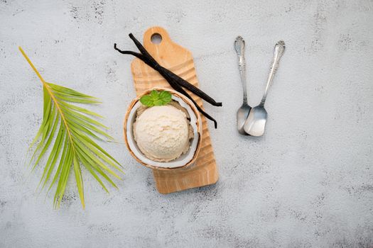 Coconut ice cream flavours in half of coconut setup on white stone background. Summer and Sweet menu concept.