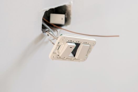 Closeup a white switch for on and off wall lighting for office and residential.