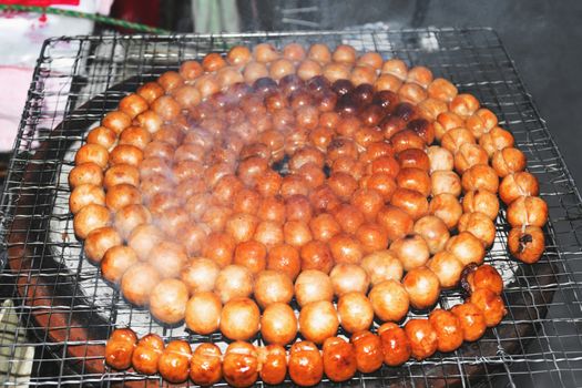 Pork sausages grilled on charcoal.