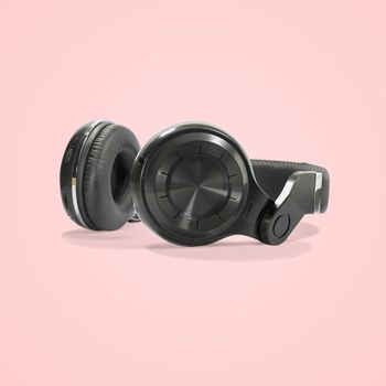 Black wireless headphone isolated on beautiful pastel color background, with clipping path.