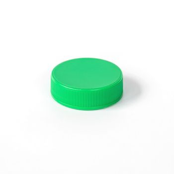 Green plastic bottle cap isolated on white background.