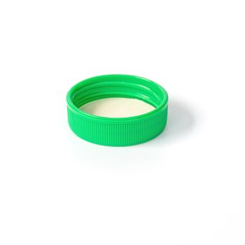 Green plastic bottle cap isolated on white background.