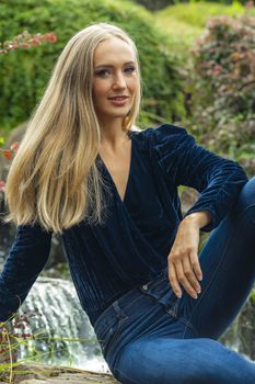 A gorgeous blonde model poses outdoors in her fall clothes