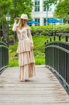 A gorgeous blonde model poses outdoors in her fall clothes