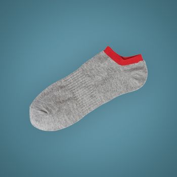 Gray short sport sock isolated on beautiful pastel color background, with clipping path.