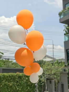 Group of orange and white balloons balloons for party decoration.