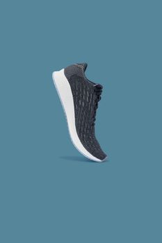 Fashion running sneaker shoe isolated on blue background.