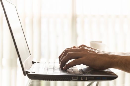 Close-up hands of businessmen are using laptops in the office.