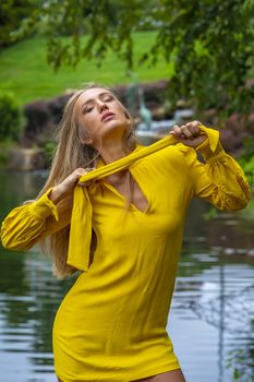 A gorgeous blonde model poses outdoors in her fall clothes