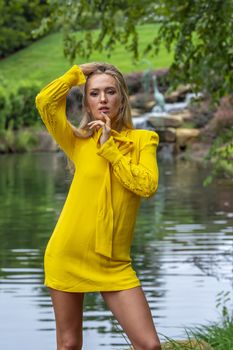 A gorgeous blonde model poses outdoors in her fall clothes