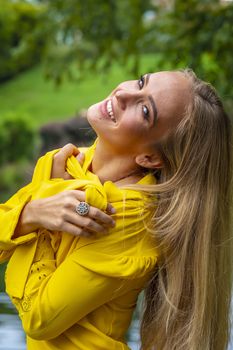 A gorgeous blonde model poses outdoors in her fall clothes