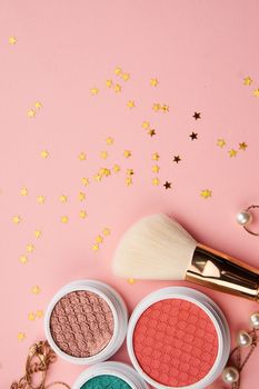 Eyeshadows and makeup brushes on a pink background Copy Space top view. High quality photo