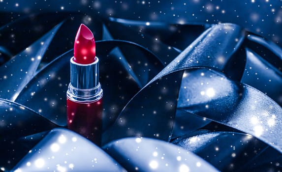 Red lipstick on blue silk and shiny glitter background, luxury make-up and beauty cosmetics