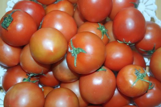 Close-up view of red tomatoes in market for sale. A fruit background for text and advertisements
