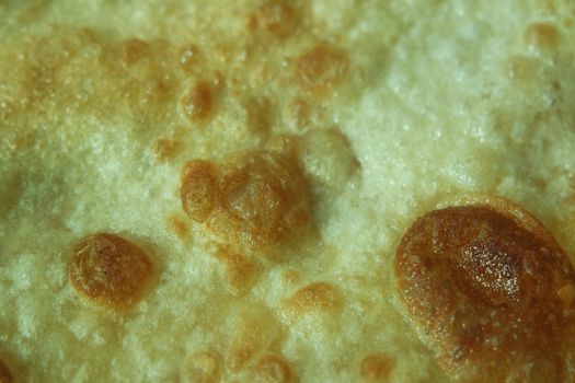 Closeup view of hand made plain bread in oil called paratha roti. Paratha is popular in India, Pakistan and other South Asian countries. Texture for bread.
