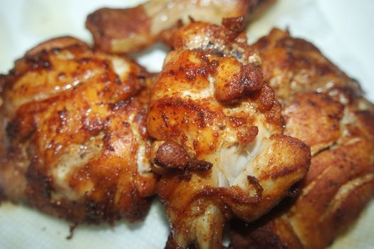 Fried, grilled baked chicken pieces with marinated spices on it. Tasty delicious fried chicken barbecue