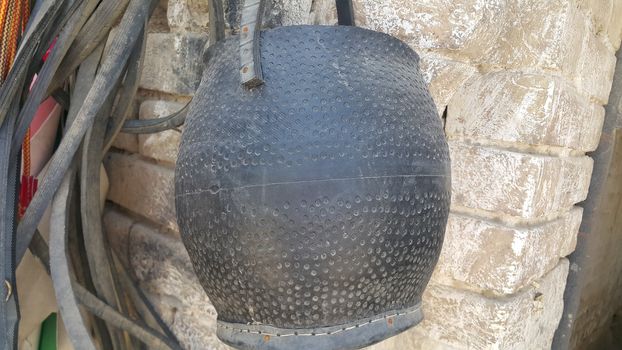 Closeup of hanging leather water bags made from automobile tires recycling. This leather water bad is called mashkeeza and used in olden days for carrying water in desserts