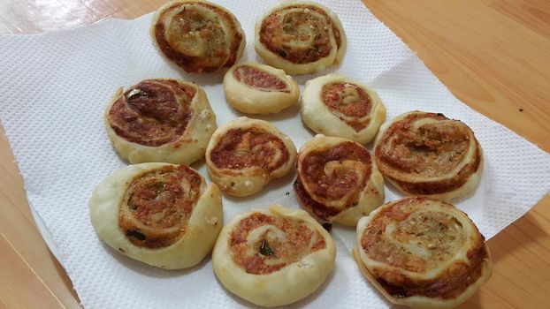 Closeup of delicious home made pinwheel puff pastries food item placed over white background