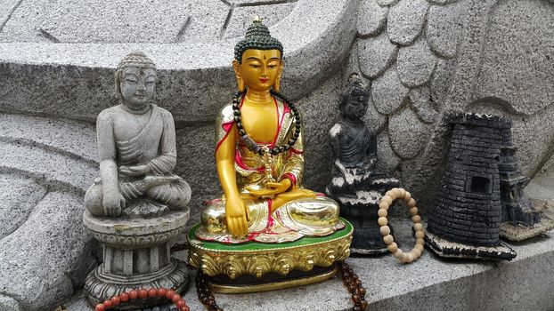 Closeup view of statues of religious monks. Buddha mini statue with beautiful background