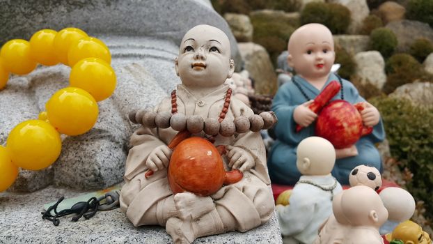 Closeup view of statues of religious monks. Buddha mini statue with beautiful background