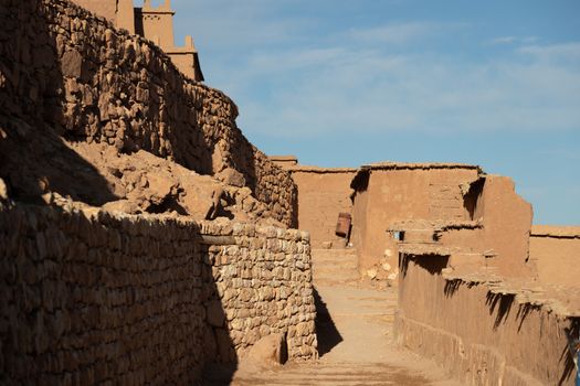 Alleyways in Ait Ben Haddou ksar Morocco, ancient fortress that is a Unesco Heritage site. Beautiful late afternoon light with honey, gold coloured mud brick construction the kasbah, or fortified town dates from 11th cent. and is on the former caravan route from the Sahara and Marrakech. The location has been used for many famous movies. High quality photo