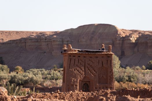 Ait Ben Haddou ksar Morocco, ancient fortress that is a Unesco Heritage site. Beautiful late afternoon light with honey, gold coloured mud brick construction the kasbah, or fortified town dates from 11th cent. and is on the former caravan route from the Sahara and Marrakech. The location has been used for many famous movies. High quality photo