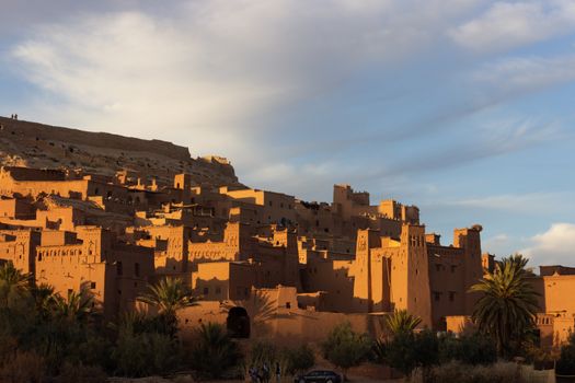 Ait Ben Haddou ksar Morocco, ancient fortress that is a Unesco Heritage site. Beautiful late afternoon light with honey, gold coloured mud brick construction the kasbah, or fortified town dates from 11th cent. and is on the former caravan route from the Sahara and Marrakech. The location has been used for many famous movies. High quality photo