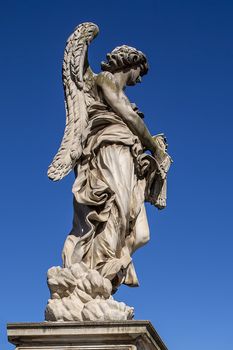 Statue of a monument to an angel on a background of blue sky