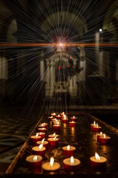 The concept of occultism astrology magic. Candles are burning in a dark church. A star shines from above, from which rays of light emanate.