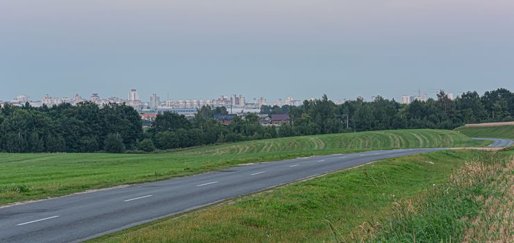 Landscape. country road in the field near the forest. Stock photo