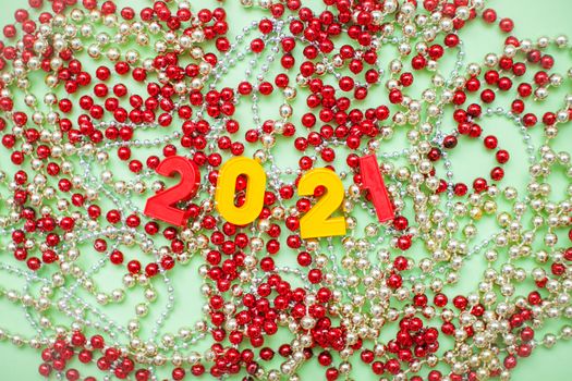 Happy New year 2021 celebration. The inscription 2021 on the background of New Year's decorations: gold and red shiny beads