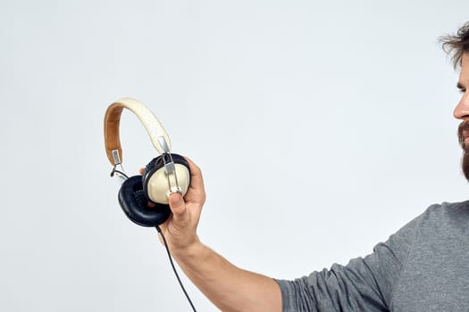 Man holding headphones in the hands of a man lifestyle modern style technology cropped view. High quality photo