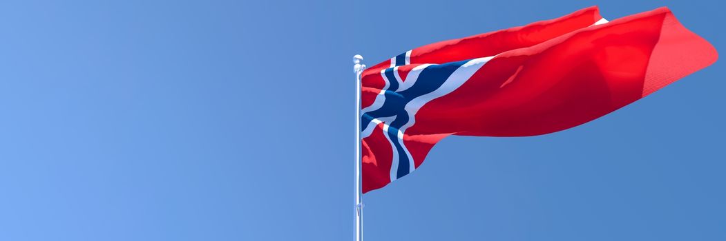 3D rendering of the national flag of Norway waving in the wind against a blue sky