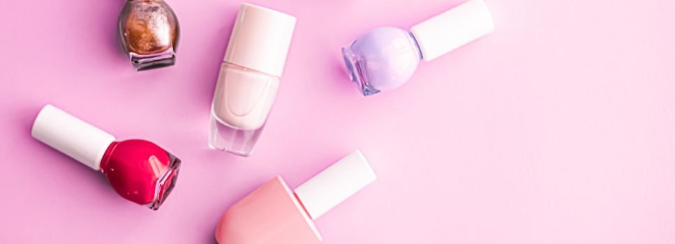 Nail polish bottles on pink background, beauty branding