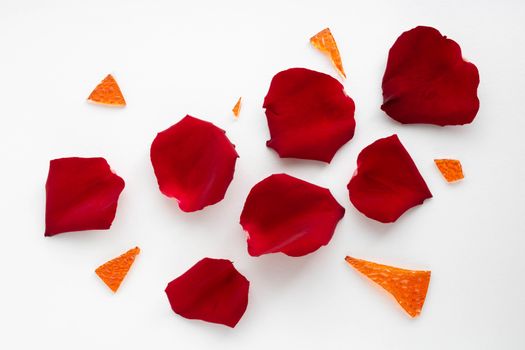 Red rose petals and orange glass shards.
