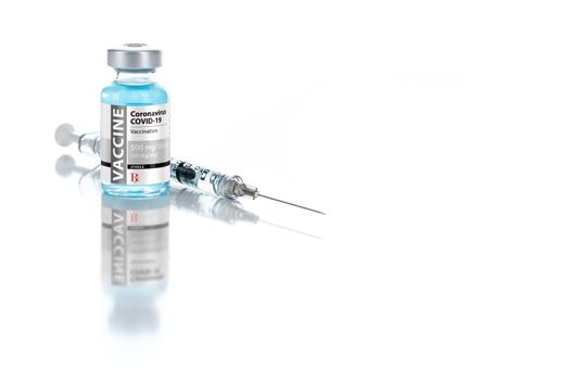 Coronavirus COVID-19 Vaccine Vial and Syringe On Reflective White Background.