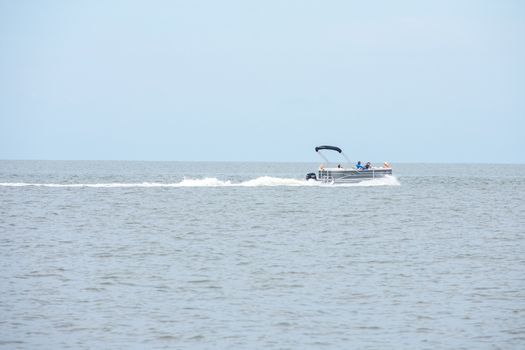 A Boat Speeding Through the Ocean On a Cloudy Day