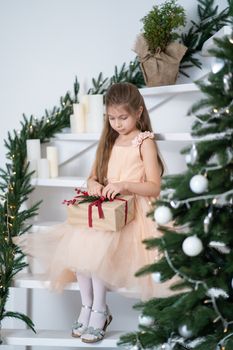 Little girl in princess dress celebrates christmas. Christmas magic fairy tale. Happy childhood.