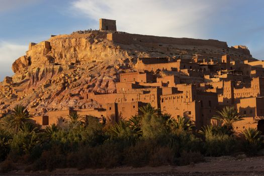 Ait Ben Haddou ksar Morocco, ancient fortress that is a Unesco Heritage site. Beautiful late afternoon light with honey, gold coloured mud brick construction the kasbah, or fortified town dates from 11th cent. and is on the former caravan route from the Sahara and Marrakech. The location has been used for many famous movies. High quality photo