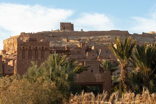 Ait Ben Haddou ksar Morocco, ancient fortress that is a Unesco Heritage site. Beautiful late afternoon light with honey, gold coloured mud brick construction the kasbah, or fortified town dates from 11th cent. and is on the former caravan route from the Sahara and Marrakech. The location has been used for many famous movies. High quality photo