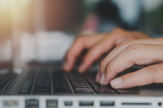 Close up businessman hand typing a computer laptop keyboard.Work using a computer, searching the web, online, communicating Concept technology business.