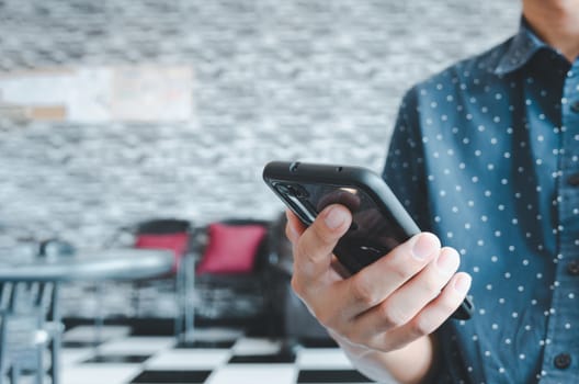 man using mobile smart phone  in coffee shop.copy space