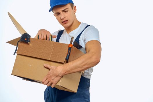 A man in a working uniform with a box in his hand loading a delivery service. High quality photo