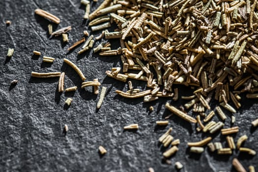 Rosemary closeup on luxury stone background as flat lay, dry food spices and recipe ingredients