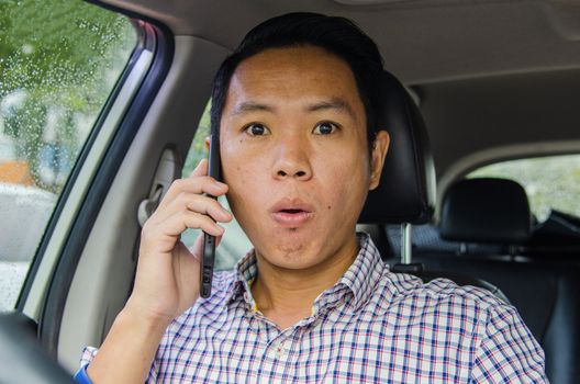 man in a scotch shirt with a shocked look on the phone