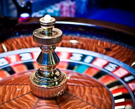 Roulette wheel in casino, gambling ads