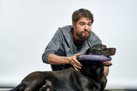 happy owner with pet black dog training model emotions. High quality photo