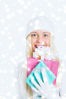 Magical Christmas and glitter snow background, happy blonde model with gift boxes in winter season for shopping sale and holiday brands