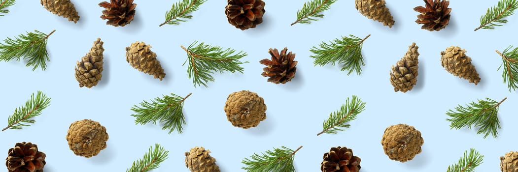 Creative Pine cone Christmas background on blue. Pine branches and cones. minimal creative cone arrangement pattern. flat lay, top view. new year background wallpaper. Nature pinecone modern christmas Background