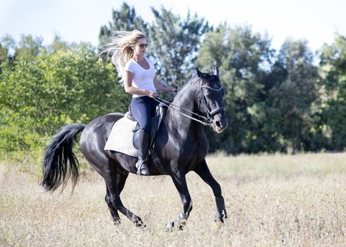  riding girl are training her black horse